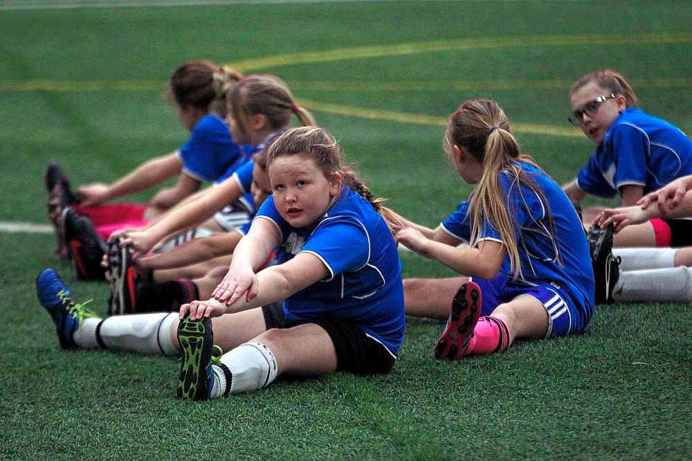 PHIL HOSSACK / WINNIPEG FREE PRESS
U10 Girls Oakbank CC players getting in some pre-game stretches.