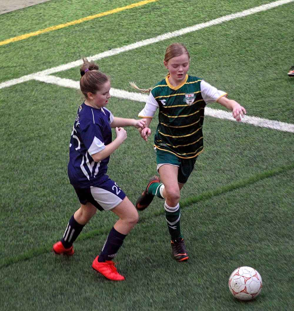 PHIL HOSSACK / WINNIPEG FREE PRESS
U10 Girls Ð Bonivital SC player Krisanna Fedoruk defends against an attacking FC Northwest player Logan Waller who scored both FCNW goals in a 2-0 victory.