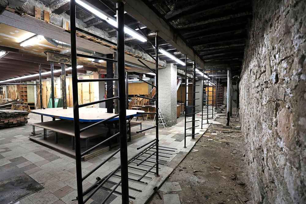 Ruth Bonneville
The century-old foundation walls with heavy metal bars used to hold bolts of fabric on left side.