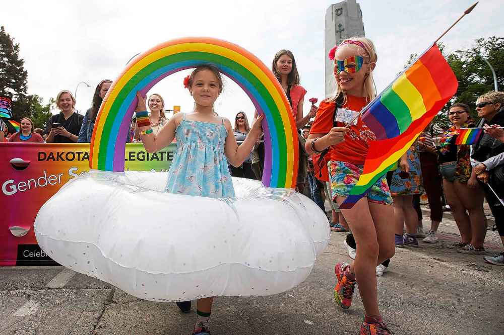 Saoirse Ford carries her rainbow at Pride parade.