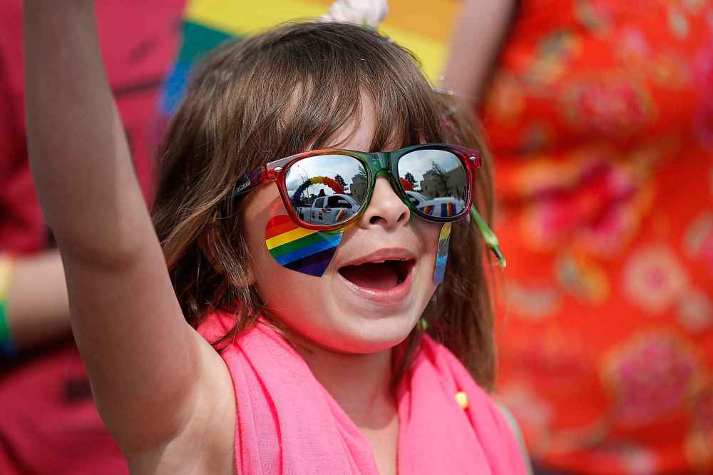 Marcia Van Steelandt, 6, waves her flag at Pride parade.