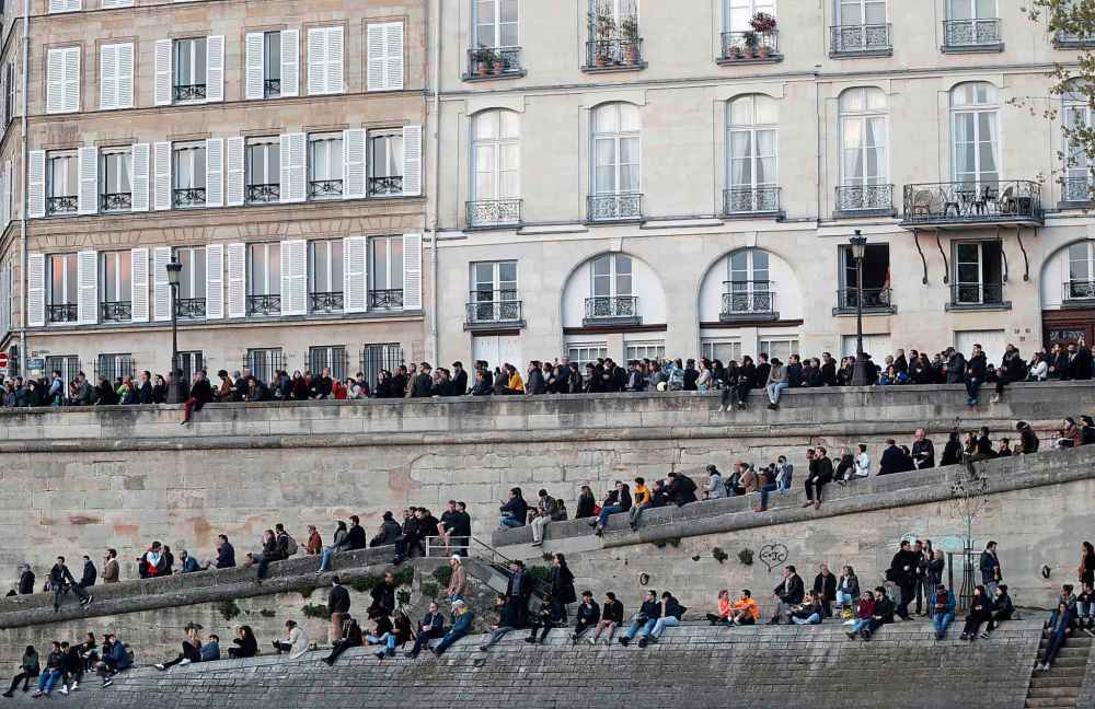 People watch as flames and smoke rise from Notre Dame cathedral (Thibault Camus / The Associated Press)
