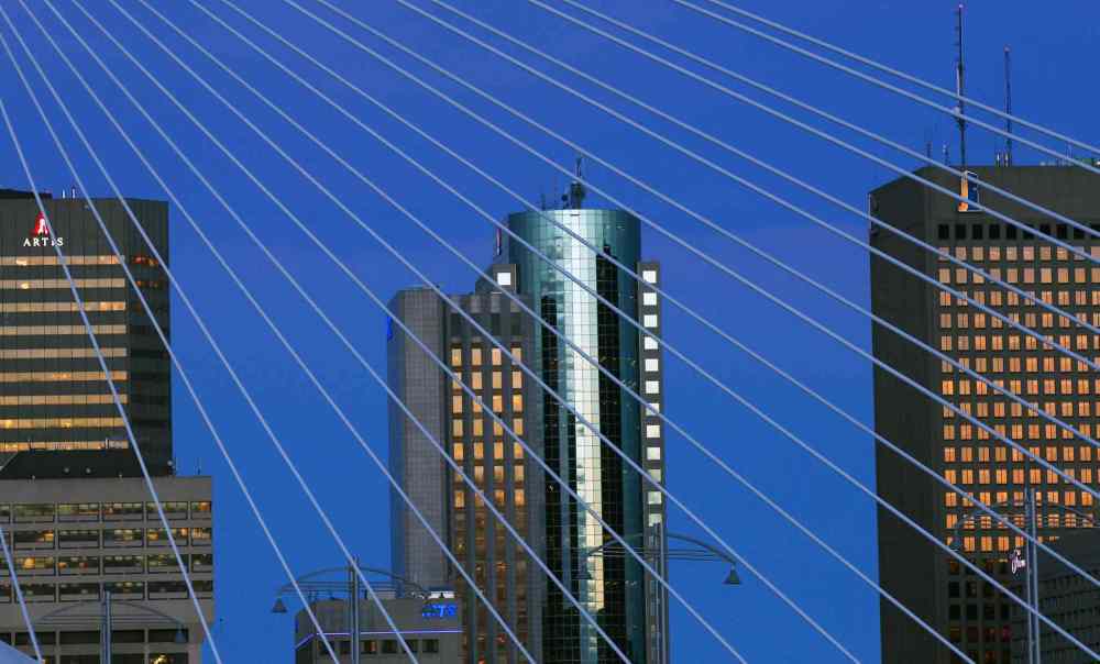 Sharp morning light on the downtown skyline in Winnipeg framed through the Esplanade Riel. December 03, 2015 (JOE BRYKSA / WINNIPEG FREE PRESS)
