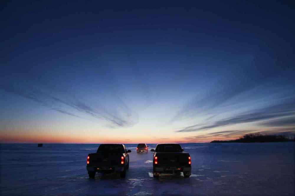 Before the sun rises, ice fisherman head out on Lake Winnipeg approximately 45 km north of Winnipeg to their ice huts to fish for walleye. February 25, 2015 (JOE BRYKSA / WINNIPEG FREE PRESS)