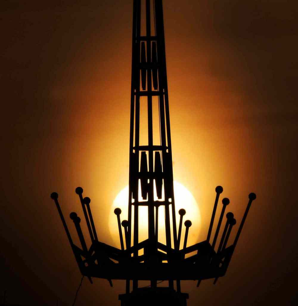 The sun rises behind the steeple on St. John's College at University of Manitoba. March 04, 2015 (JOE BRYKSA / WINNIPEG FREE PRESS)