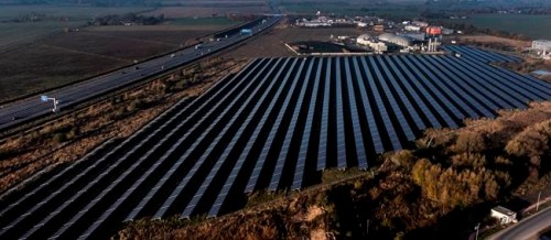 FILE -- A solar farm, front, and a biogas plant, rear, are seen in Oberkraemer, Germany, Thursday, Oct. 28, 2021. The German government presented a major package of reforms Wednesday to boost the construction of renewable power as part of its efforts to meet its climate goals and become independent of energy imports from hostile nations such as Russia. (AP Photo/Michael Sohn, file)