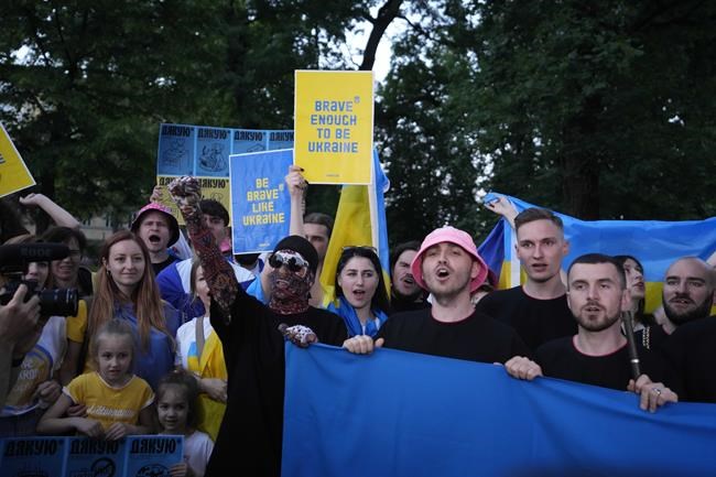Kalush Orchestra from Ukraine hold Ukrainian flag as they meet with Ukrainian community during a flash mob at the Eurovision Village in Turin, Italy, Wednesday, May 11, 2022. (AP Photo/Luca Bruno)