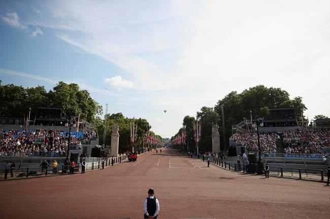 A police officer stands looking down The Mall to Admiralty Arch in London, Thursday June 2, 2022, on the first of four days of celebrations to mark the Platinum Jubilee. The events over a long holiday weekend in the U.K. are meant to celebrate the monarch’s 70 years of service. (Hannah McKay/Pool Photo via AP)