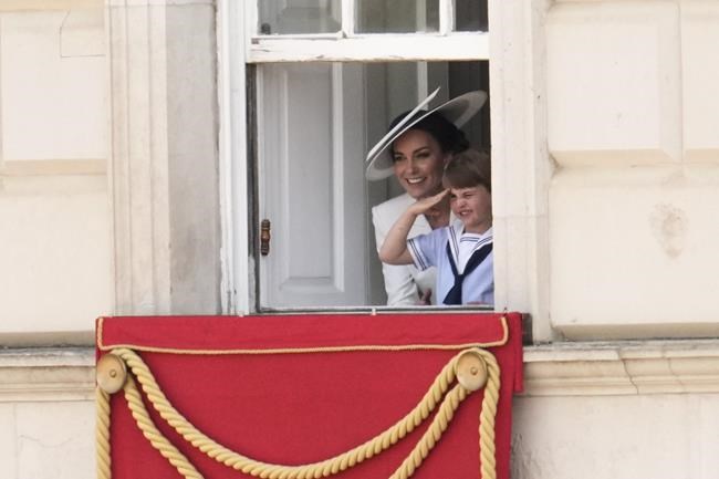 Britain's Kate, Duchess of Cambridge stands next to Prince Louis saluting as they watch the Trooping the Color parade at Horse Guards, London, Thursday, June 2022, on the first of four days of celebrations to mark the Platinum Jubilee. The events over a long holiday weekend in the U.K. are meant to celebrate the monarch's 70 years of service.(AP Photo/Matt Dunham)
