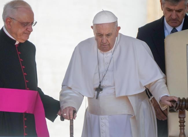 FILE Pope Francis walks with a cane as he arrives for his weekly general audience in St. Peter's Square at The Vatican, Wednesday, June 1, 2022. Pope Francis canceled a planned July trip to Africa on doctors' orders because of ongoing knee problems, the Vatican said Friday, June 10, 2022, raising further questions about the health and mobility problems of the 85-year-old pontiff. (AP Photo/Gregorio Borgia)