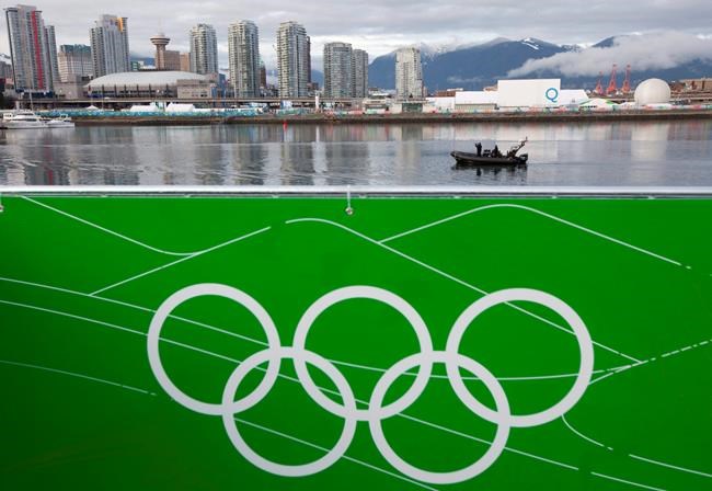 Police officers patrol the waters of False Creek by boat near the athletes village and GM Place in downtown Vancouver, Tuesday, Feb. 2, 2010. An Indigenous-led partnership is moving ahead with plans to host the 2030 Winter Olympics in Vancouver and Whistler. THE CANADIAN PRESS/Jonathan Hayward