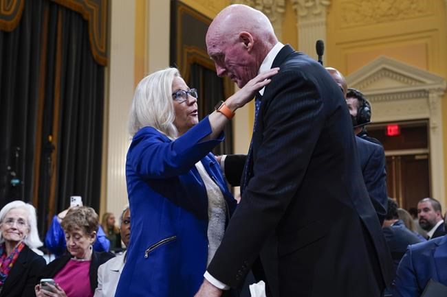 Vice chair Rep. Liz Cheney, R-Wyo., hugs Rusty Bowers, Arizona state House Speaker, during a break as the House select committee investigating the Jan. 6 attack on the U.S. Capitol continues to reveal its findings of a year-long investigation, at the Capitol in Washington, Tuesday, June 21, 2022. (AP Photo/Jacquelyn Martin)
