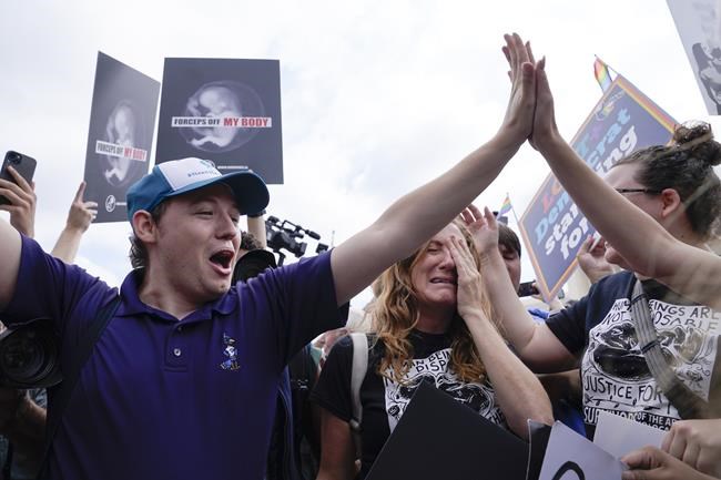 People celebrate outside the Supreme Court, Friday, June 24, 2022, in Washington. The Supreme Court has ended constitutional protections for abortion that had been in place nearly 50 years, a decision by its conservative majority to overturn the court's landmark abortion cases. (AP Photo/Jacquelyn Martin)