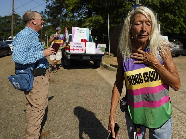 Veteran Pink House defender Derenda Hancock reacts to anti-abortion activist Coleman Boyd's protesting outside the Jackson Women's Health Organization clinic in Jackson, moments before the U.S. Supreme Court ruling overturning Roe v. Wade was issued, Friday, June 24, 2022. The clinic is the only facility that performs abortions in the state. (AP Photo/Rogelio V. Solis)