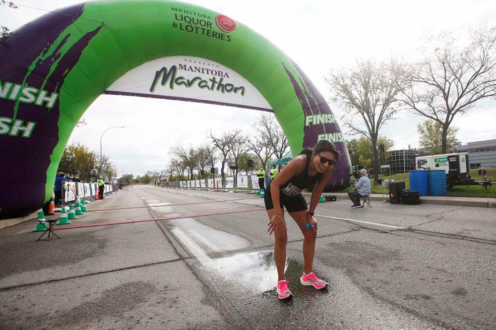 JOHN WOODS / WINNIPEG FREE PRESS
Melissa Raven the first woman to cross the half marathon finish line at the Manitoba Marathon.