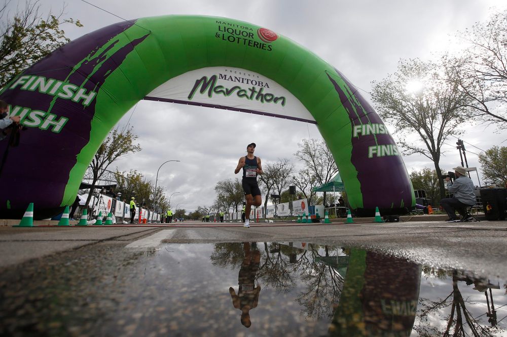 JOHN WOODS / WINNIPEG FREE PRESS
Mike Wood, one of the first men to cross the half marathon finish line at the Manitoba Marathon at the University of Manitoba in Winnipeg Sunday.
