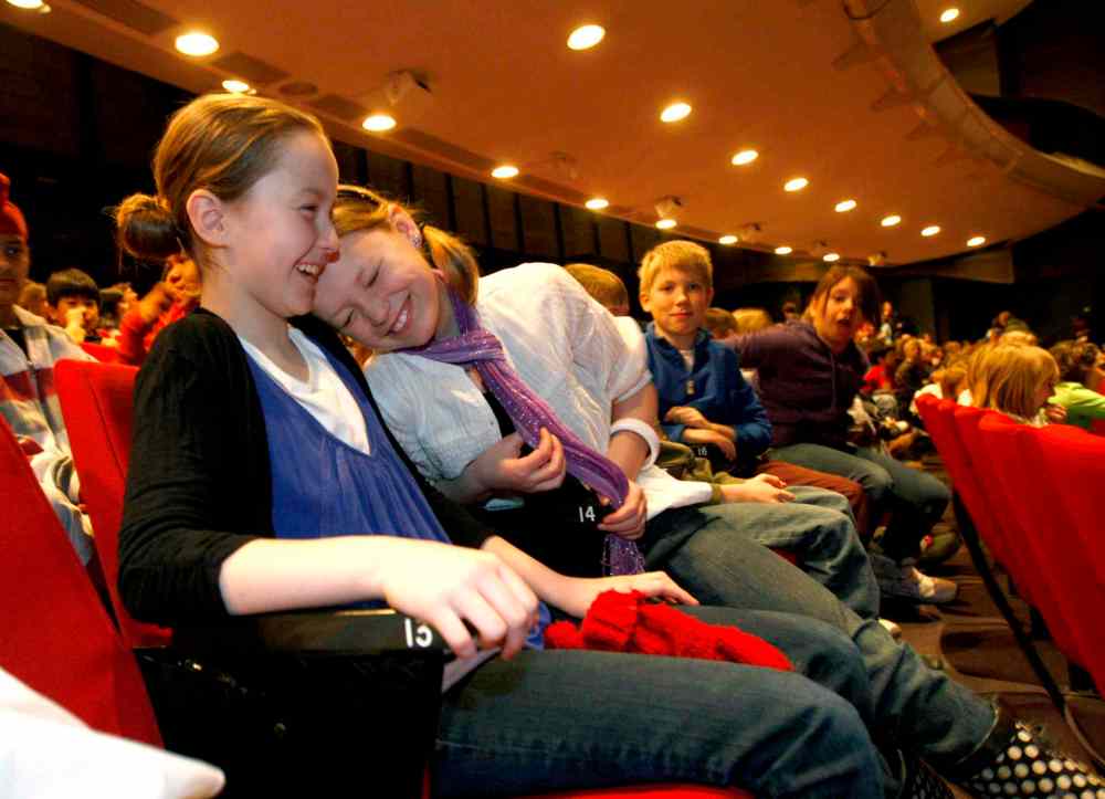 Grade 5: Sydney and Meagan giggle before seeing the Winnipeg Symphony Orchestra at the Concert Hall. (Ruth Bonneville / Winnipeg Free Press)