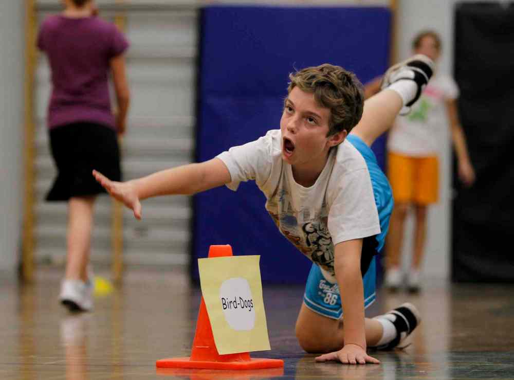 Grade 6: Quinn tries to do a bird dog during a fitness drill during gym class. (Ruth Bonneville / Winnipeg Free Press)