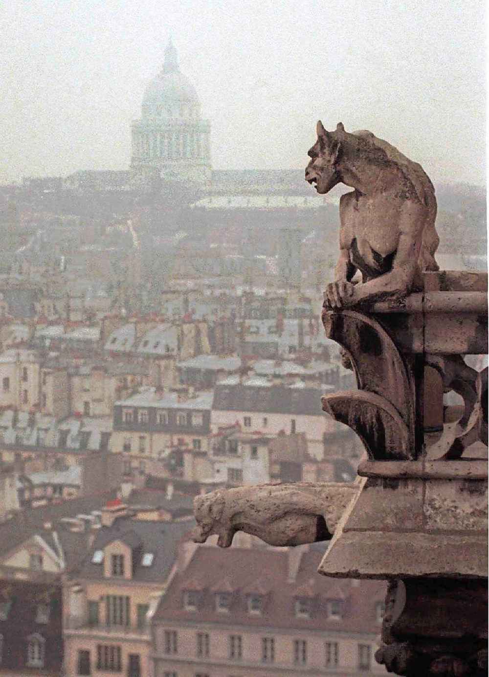 A chimera and a gargoyle watch over Paris from the top of the 11th century Notre Dame cathedral in a file photo. Architect Viollet le Duc added the chimeras and gargoyles to the tower walls when repairing the damages caused by the French Revolution. The chimeras were purely decorative while the garoyles were built to serve as raingutters. (Remy De La Mauviniere / The Associated Press files)