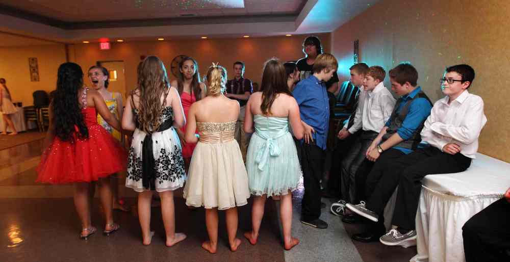 Grade 8: Girls dance together on the dance floor while boys line themselves against the wall at a farewell dinner and dance party for the students, who leave Windsor School to move on to high school. (Ruth Bonneville / Winnipeg Free Press)