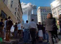 Pedestrians in lower Manhattan watch smoke billow from New York