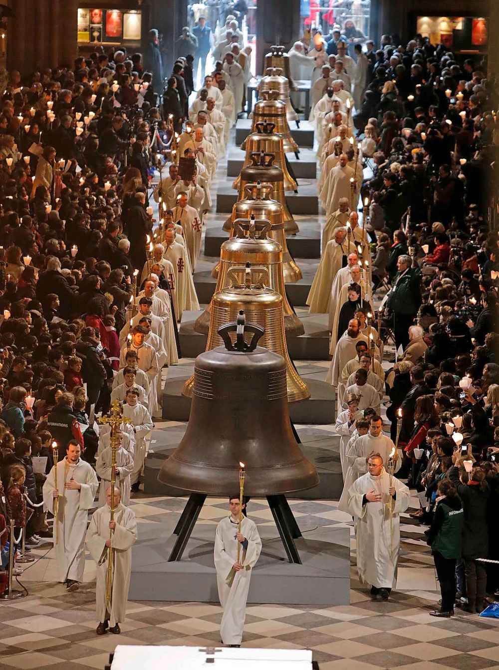 Nine new bronze bells are displayed in Notre Dame cathedral during a ceremony of blessing by Paris Archbishop Andre Vingt-Trois in Paris in 2013 (Francois Mori / The Associated Press files)