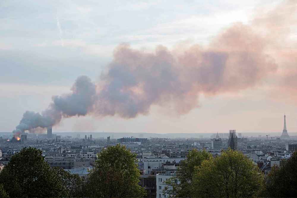 Smoke fills the air as Notre Dame cathedral burns. (Rafael Yaghobzadeh / The Associated Press)