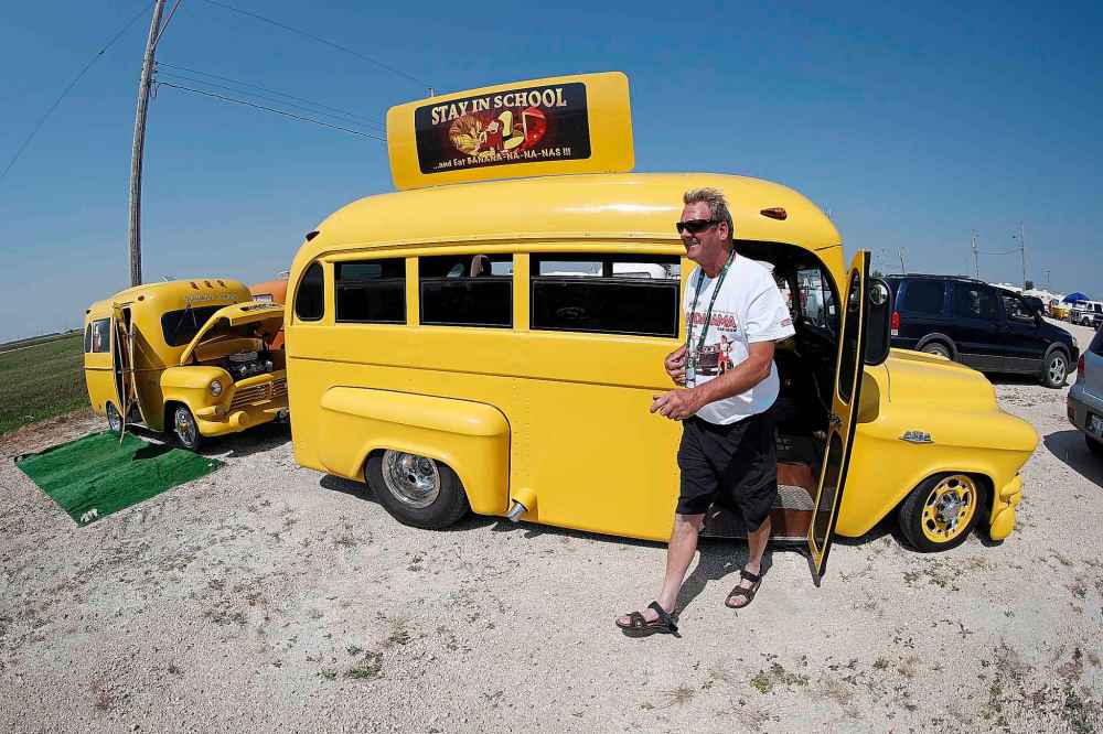 Ron Schellenberg with his yellow school bus themed trailer and 1957 school bus.