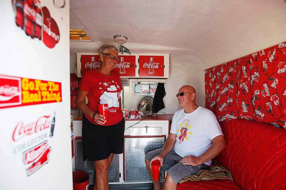 The Wiebes relax inside trailer.