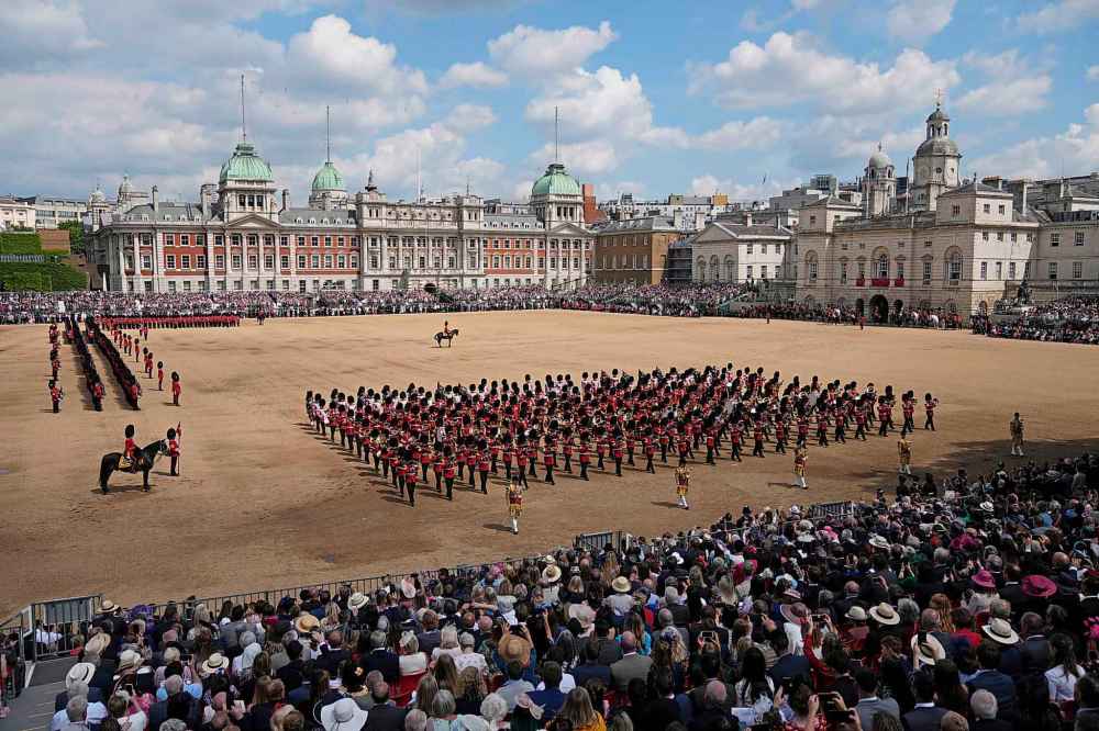 The Queen's guards march during the Trooping the Color parade at Horse Guards, London, Thursday, June 2022, on the first of four days of celebrations to mark the Platinum Jubilee. The events over a long holiday weekend in the U.K. are meant to celebrate the monarch's 70 years of service.(AP Photo/Matt Dunham)