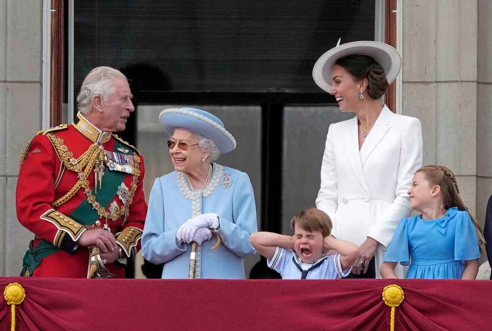 Britain's Prince Charles, left, with Queen Elizabeth II, Prince Louis her grandson, covering his ears with his hands, next to his mother Kate Duchess of Cambridge and Princess Charlotte her daughter, at right, stand on the balcony of Buckingham Palace. (AP Photo/Alastair Grant)