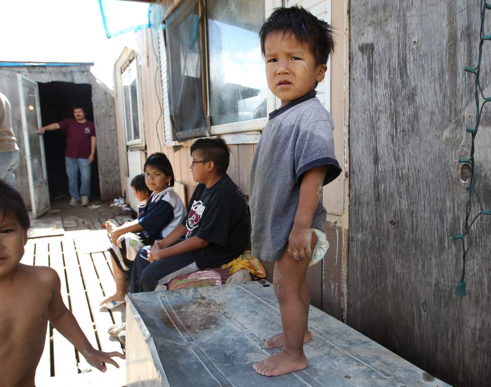 Wasagamack First Nation- Richard Andrews lives, often with five other adults and his seven or eight grandchildren in what is likely the most squalid home on the reserve with the most pressing sanitation problems in the province. There is no running water to wash clothes, bathe the gaggle of muddy toddlers, do dishes or keep the floors clean. The family shares a slop pail, lined with a garbage bag, in what passes for a bathroom.
(JOE BRYKSA / WINNIPEG FREE PRESS)