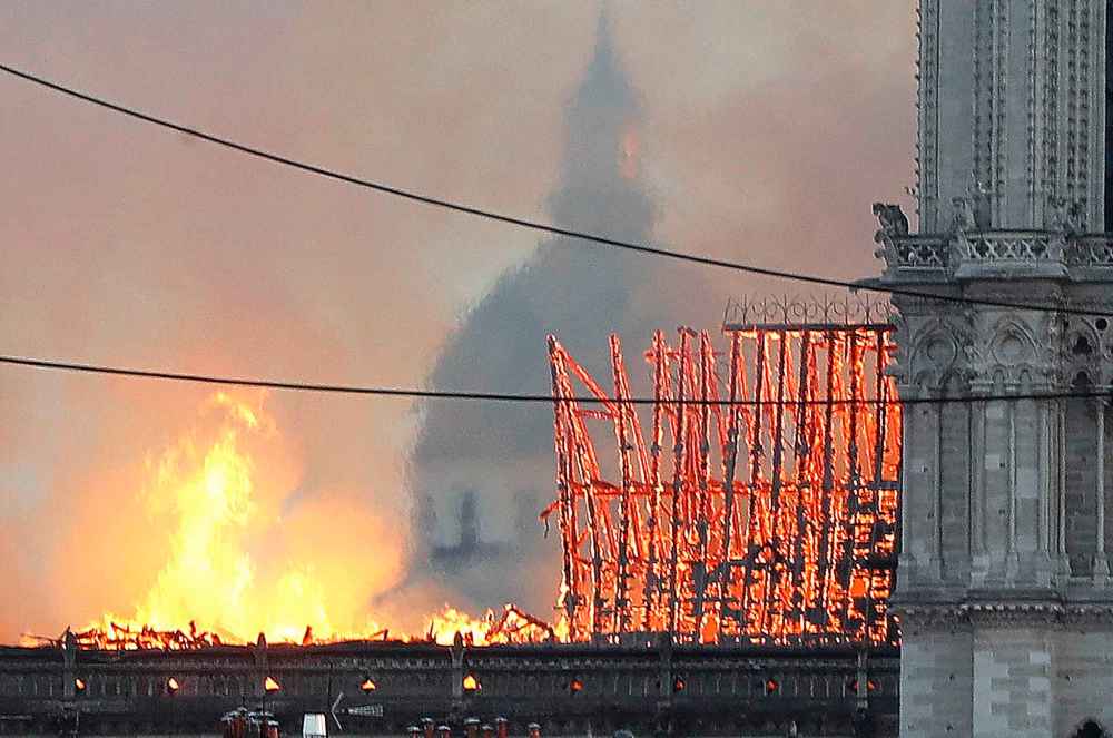 Flames rise from Notre Dame cathedral as it burns. (Thibault Camus / The Associated Press)