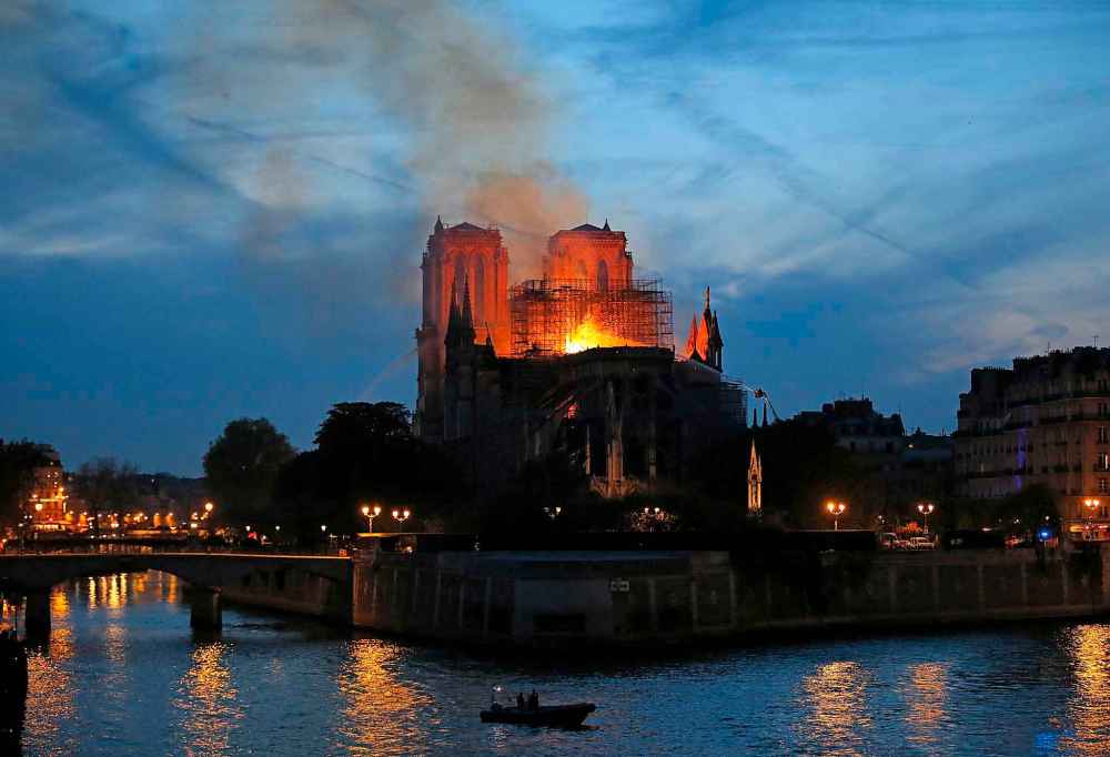 Firefighters tackle the blaze. (Michel Euler / The Associated Press)