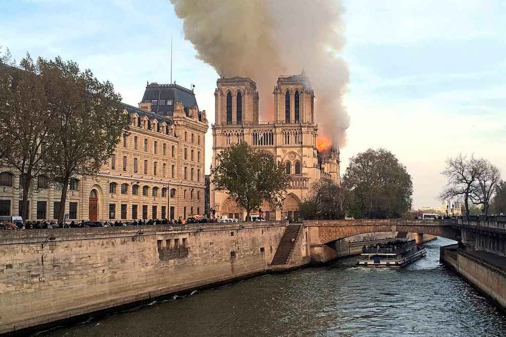 Ash fell on tourists and others around the island that marks the center of Paris. (Lori Hinant / The Associated Press)