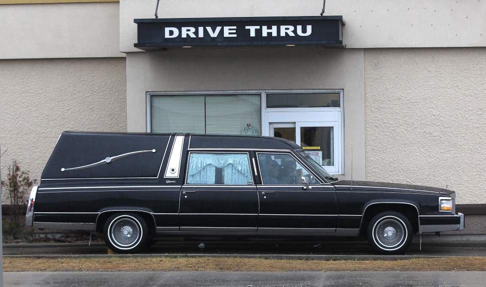 A hearse waits at the Kentucky Fried Chicken outlet drive through at Notre Dame Avenue and Sherbrook Street.
Tuesday, March 27, 2012
(JOE BRYKSA / WINNIPEG FREE PRESS)