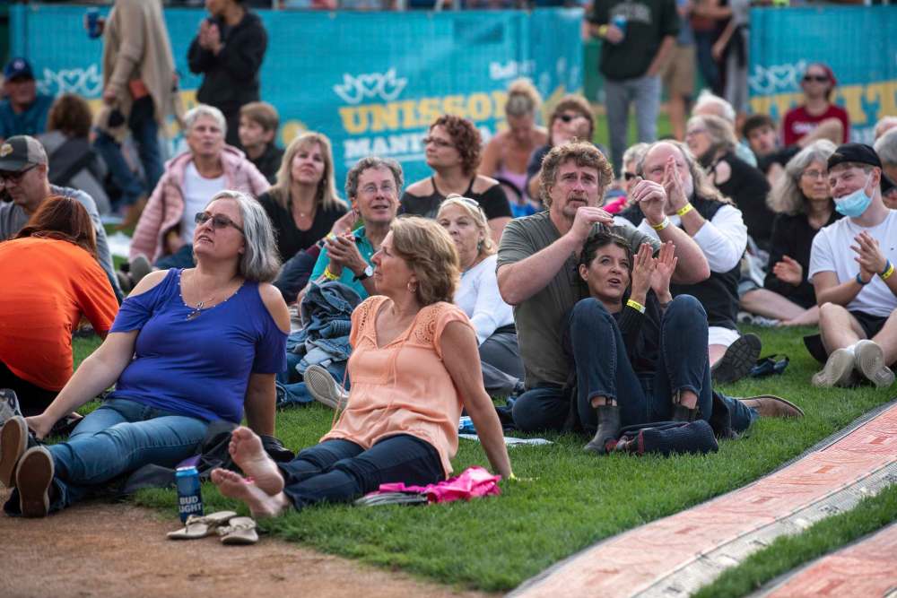 Concert goers take in the view of the show from Shaw Park's baseball field. (Alex Lupul / Winnipeg Free Press)