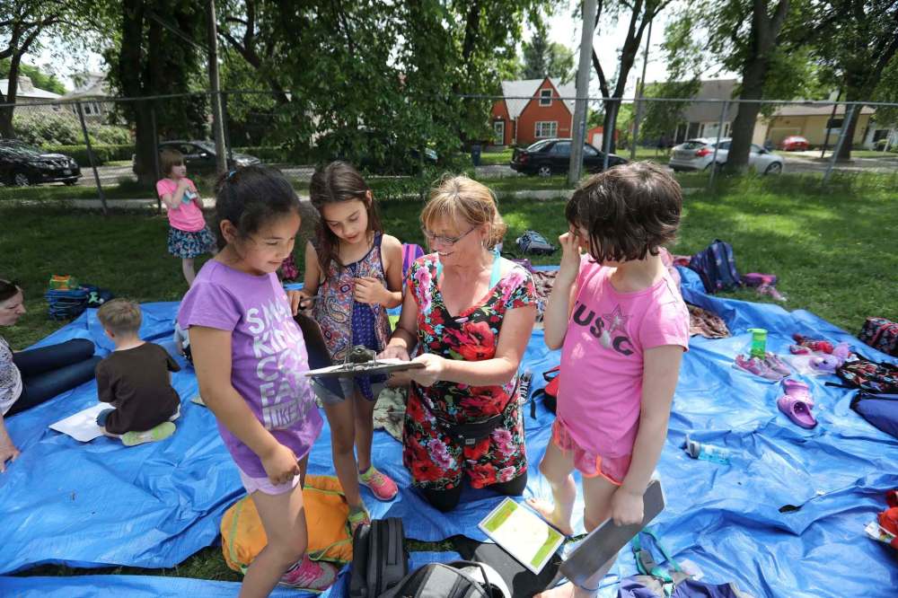 ABOVE: Students read, write, paint, do performing arts classes, dance, gym and gather together at the start of the day in a circle in middle of their field as they challenge themselves to do school outside.