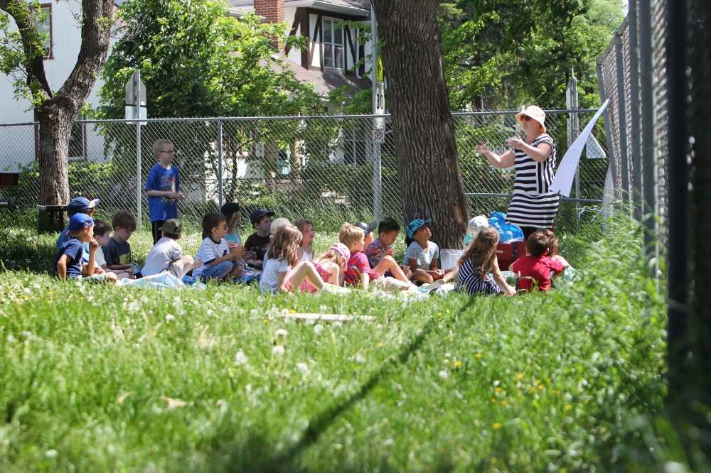 Performance arts teacher Erin Hammond finds a corner of the schoolyard to conduct her class.