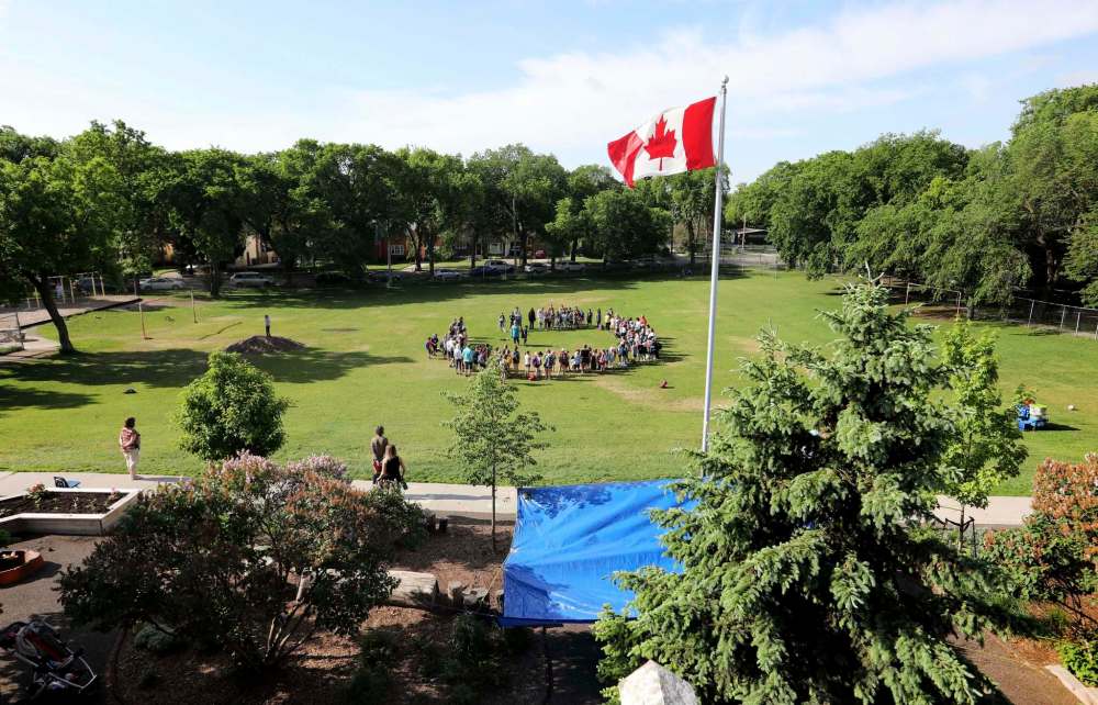 RUTH BONNEVILLE / WINNIPEG FREE PRESS
Students at Wolseley School gather in the yard for Oh Canada.
June 07, 2017