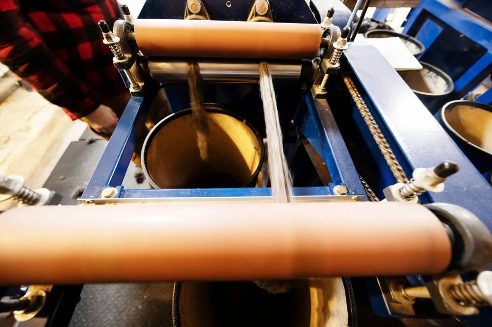 Wool roving passing through the draw frame machine. This further aligns the fibre in order to make smooth yarn. (Prabhjot Singh Lotey / Winnipeg Free Press)