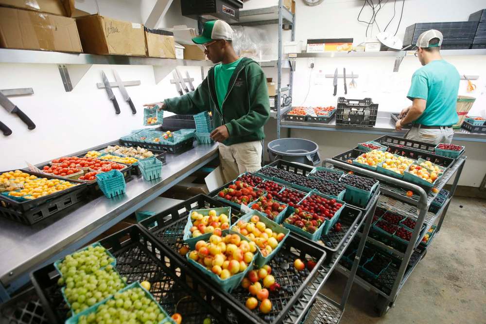 Kenan Kamanga and Blake Hunnie prepare the berry baskets.