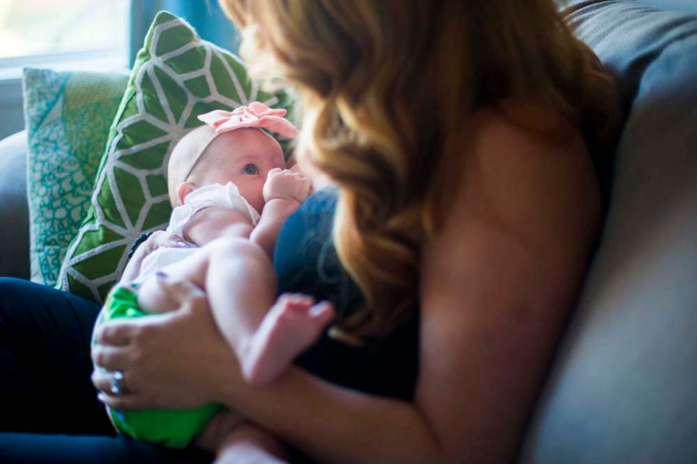 Jenn Kiziak breastfeeds Aurora.