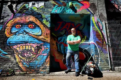 Dan Gordon cleans up the streets in and around Osborne Village where he picks up garbage and sweeps up debris, all on his own accord. (Ruth Bonneville / Winnipeg Free Press)
