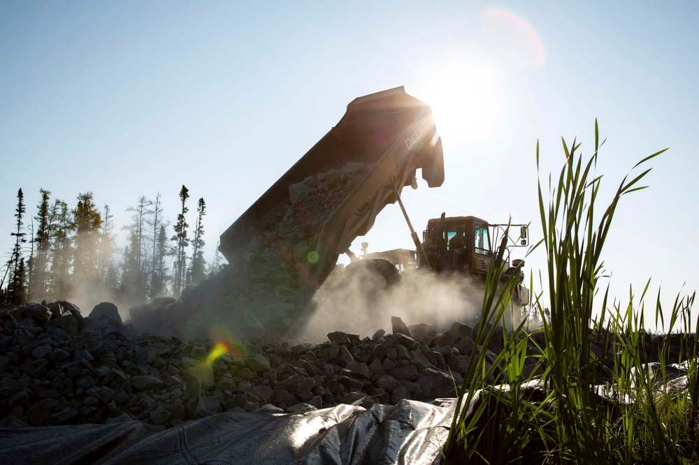 ANDREW RYAN / WINNIPEG FREE PRESS
A dump truck unloads nearly 40 tonnes of rock forming one small step forward for Freedom Road on July 29, 2018.