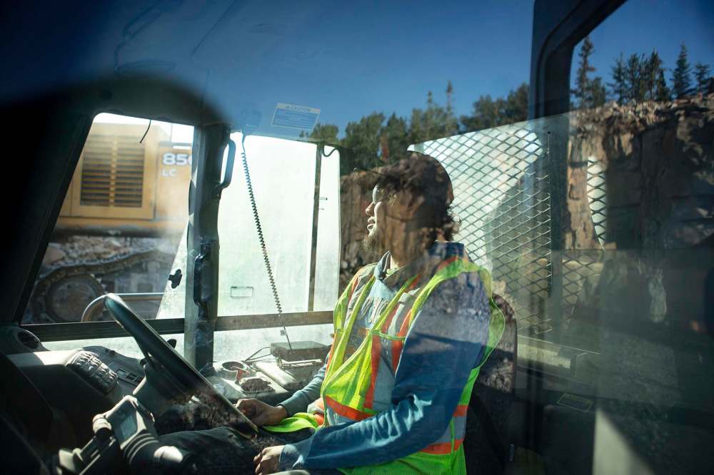 ANDREW RYAN / WINNIPEG FREE PRESS
Franklin Major, who became a father in August, watches as an excavator dumps 40 tonnes of rock into his dump truck on Freedom Road. July 29.