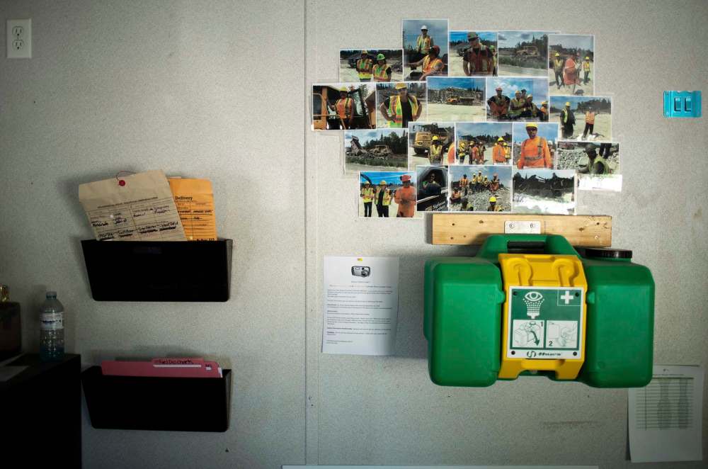 ANDREW RYAN / WINNIPEG FREE PRESS
A grouping of photographs of Shoal Lake 40 workers hangs in the briefing room of the man camp at the beginning of Freedom Road.