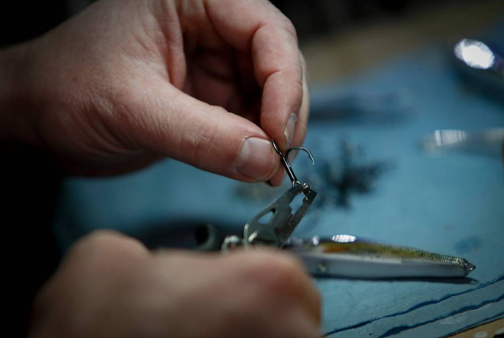 JOHN WOODS / WINNIPEG FREE PRESS
Mike Harris, owner of Element Custom Baits, works on his fishing lures in his basement workshop at his home in Winnipeg.