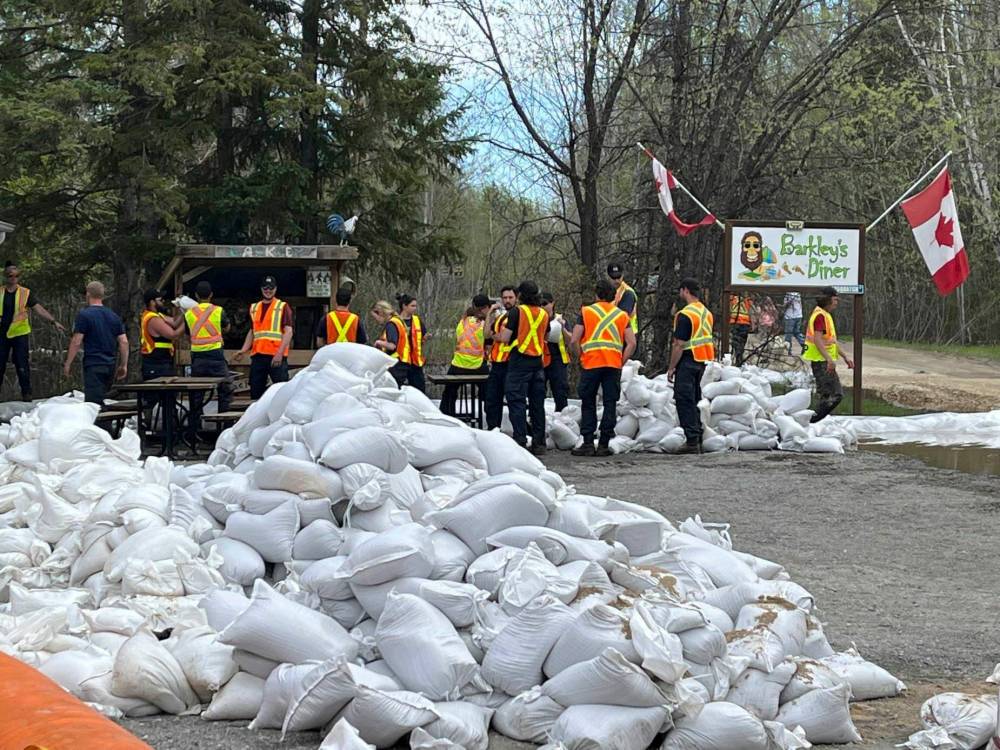 Provincial employees helped build and reinforce dikes around flood-hit Nutimik Lodge last month. (Allison Baker-Thiessen photo)