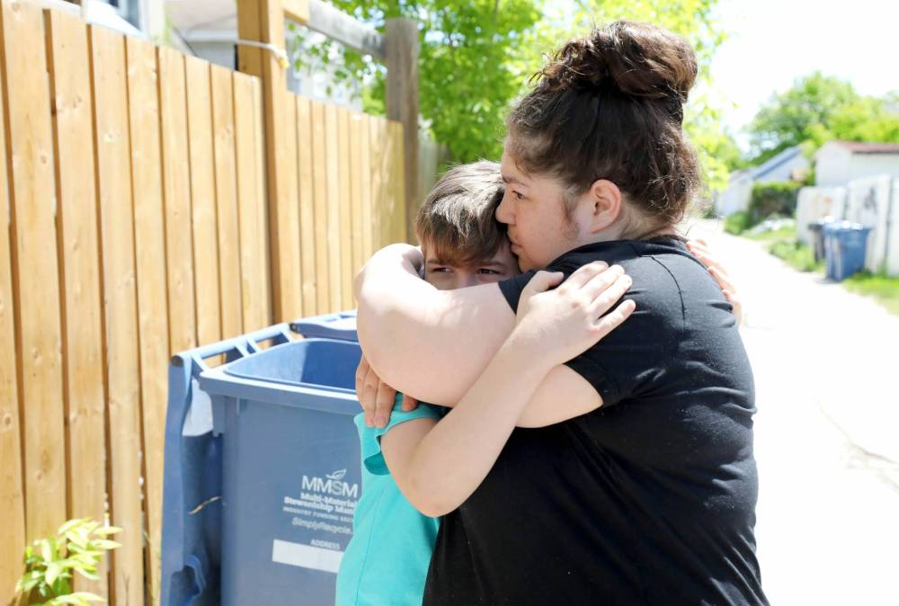 RUTH BONNEVILLE / WINNIPEG FREE PRESS FILES
The family that rents a home on Boyd Avenue mourn after hearing the news of a baby found in their garbage bin.